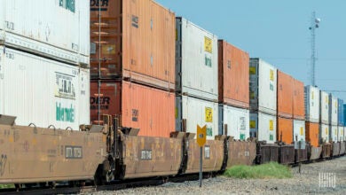 Images shows a container stack train, microwave tower and signs.