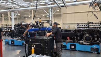 Nikola workers wrestling battery pack