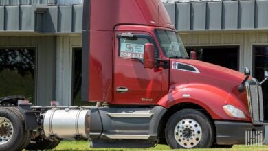 Red Kenworth T680 with for sale sign in window