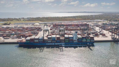 a photo of a container ship unloading imports