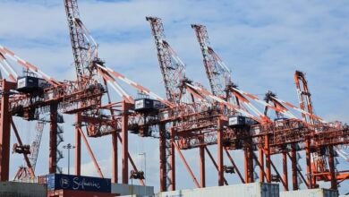 Image shows container cranes and stacks of containers.