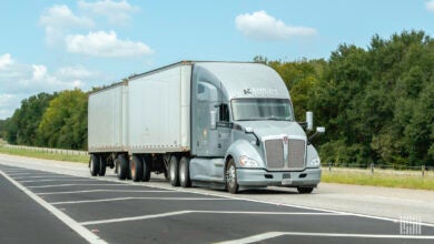 A grey Knight Transportation tractor pulling two LTL trailers