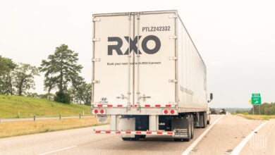 a rear view of an RXO trailer on a highway