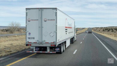 A rearview of a Forward Air trailer on a highway