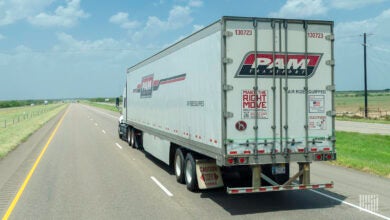 a side view of a Pam trailer on a highway