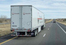 A white Forward Air dryvan trailer being pulled on a highway