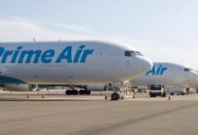 Prime Air freighters with light blue lettering lined up on the tarmac side by side.