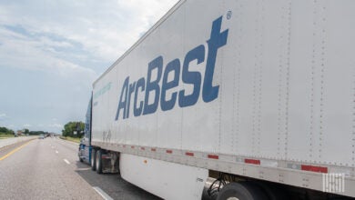 An ArcBest dryvan trailer being pulled on a highway