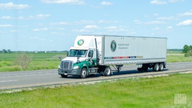 An Old Dominion day cab pulling an Old Dominion dry van trailer on a highway