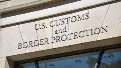 Engraved name of U.S. Customs and Border Protection over entrance door of building.