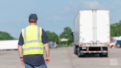 Truck driver instructor in parking lot.