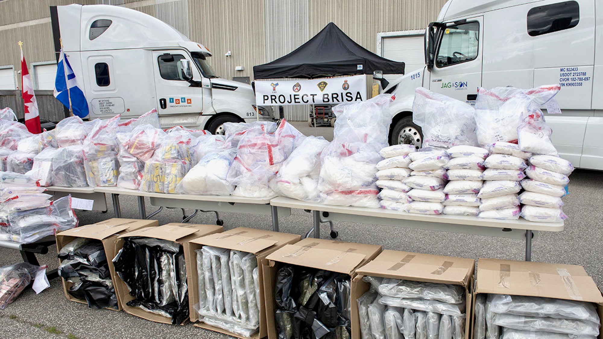 A picture of drugs and trucks seized during an investigation into drug trafficking in Canada.