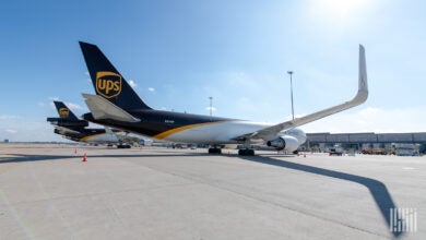 Ground view of brown-tailed UPS freighters on a sunny day, as seen from side rear.