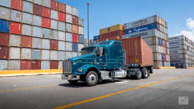 Truck hauling container from port