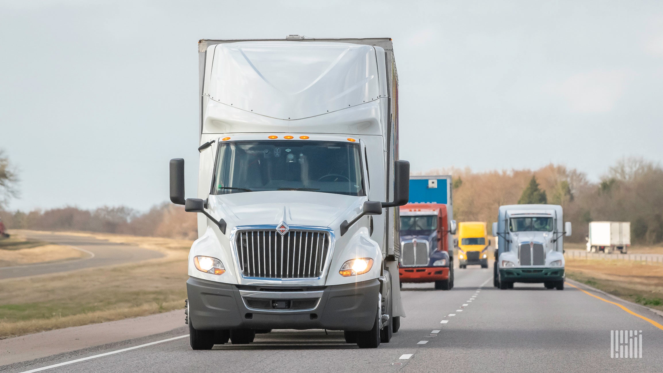 Multiple heavy trucks on highway