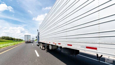 Multiple tractor-trailers moving on a highway