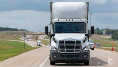 Front view of a white tractor-trailer on a highway