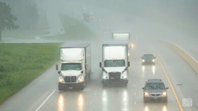 Trucks and cars on rainy highway