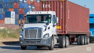 trucks with containers leaving a port