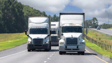 White tractors pulling trailers on a highway