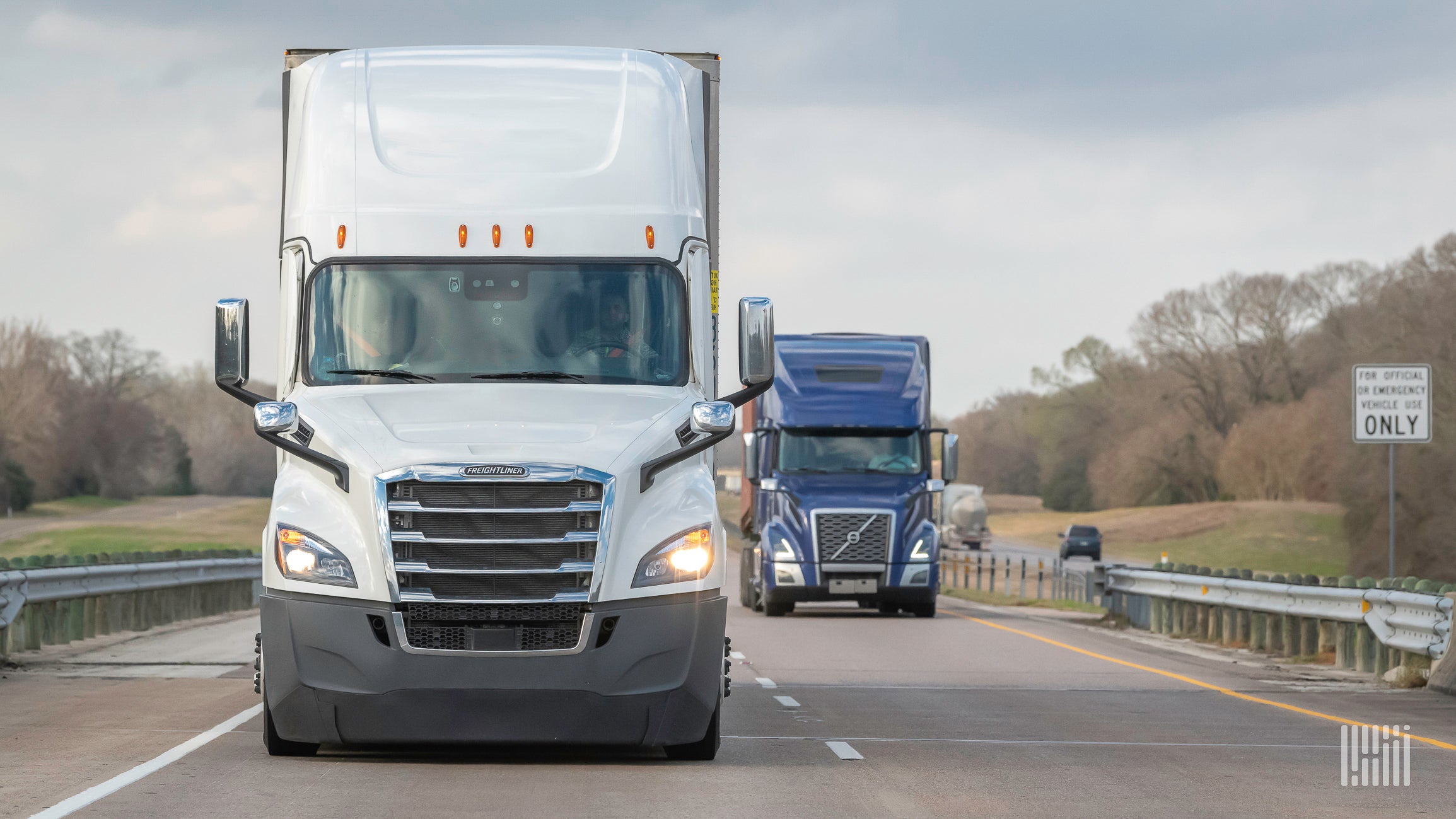 White truck traveling down the highway